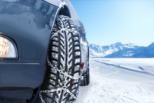 Car,with,mounted,snow,chains,in,wintry,environment