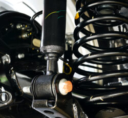 Automotive,shock,absorbers,and,springs,installed,in,cars.